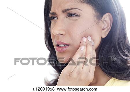 Stock Photo - Woman touching her cheek in pain. Fotosearch