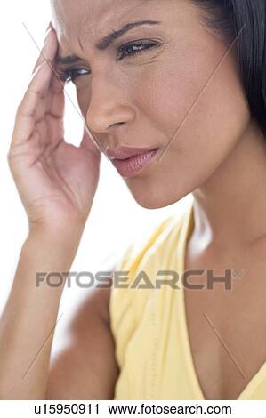 Stock Image - Woman touching her head in pain. Fotosearch