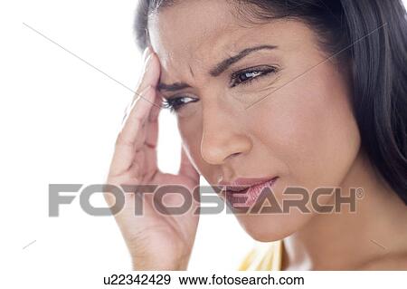 Woman touching her head in pain View Large Photo Image Stock Photo - Woman touching her head in pain. Fotosearch