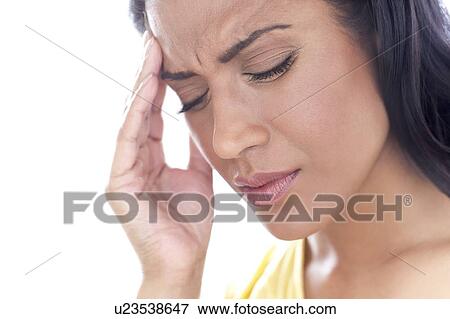 Stock Photo - Woman touching her head in pain. Fotosearch
