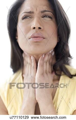 Woman touching her neck in pain View Large Photo Image Stock Photo - Woman touching her neck in pain. Fotosearch