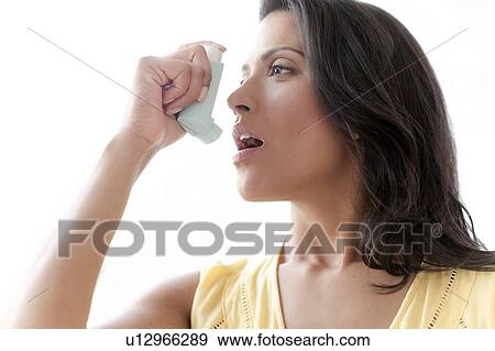 Woman using asthma inhaler View Large Photo Image Stock Photo - Woman using asthma inhaler. Fotosearch