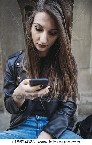 Woman using smartphone on steps View Large Photo Image Stock Image - Woman using smartphone on steps. Fotosearch