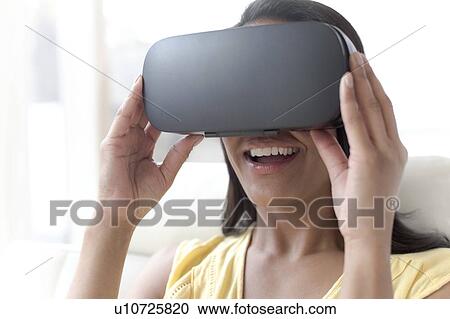 Woman wearing VR headset View Large Photo Image Stock Image - Woman wearing VR headset. Fotosearch