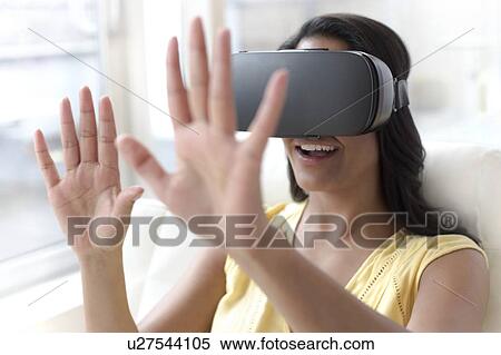 Stock Photography - Woman wearing VR headset. Fotosearch