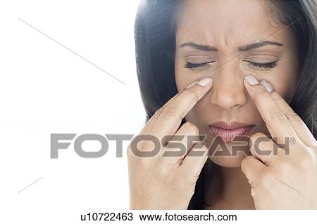 Stock Image - Woman with sinus pain. Fotosearch