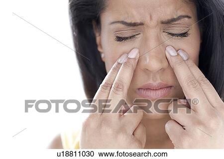 Stock Image - Woman with sinus pain. Fotosearch