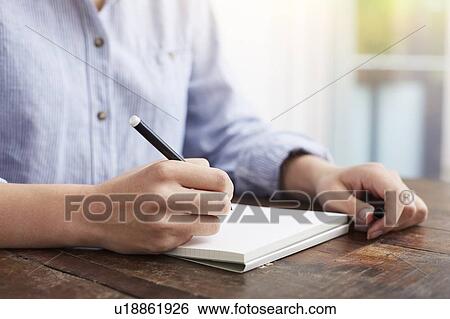 Woman writing on notebook View Large Photo Image Stock Photograph - Woman writing on notebook. Fotosearch