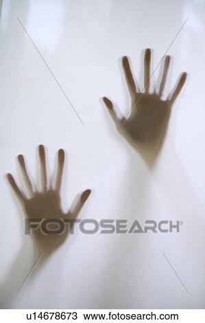 Stock Image - Woman's hands touching frosted glass. Fotosearch