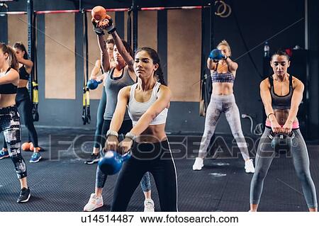 Women training in gym with kettle bells View Large Photo Image Stock Photo - Women training in gym with kettle bells. Fotosearch
