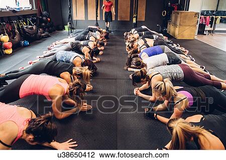 Women training in gym with male trainer, doing push ups View Large Photo Image Stock Image - Women training in gym with male trainer, doing push ups. Fotosearch