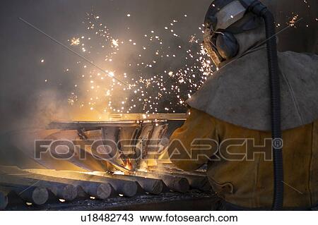 Worker cutting up scrap titanium aircraft parts in titanium recycling plant View Large Photo Image Stock Image - Worker cutting up scrap titanium aircraft parts in titanium recycling plant. Fotosearch
