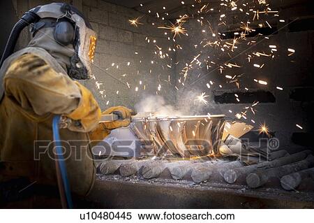Worker cutting up scrap titanium aircraft parts in titanium recycling plant View Large Photo Image Stock Photography - Worker cutting up scrap titanium aircraft parts in titanium recycling plant. Fotosearch