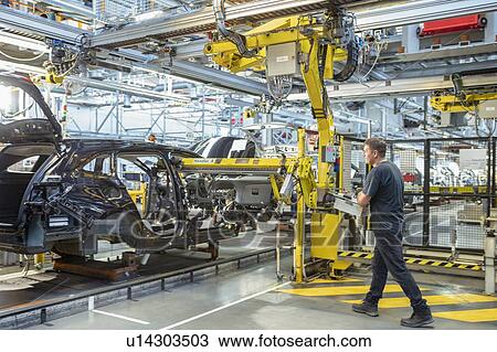 Worker inserting dashboard into car in car factory View Large Photo Image Stock Image - Worker inserting dashboard into car in car factory. Fotosearch