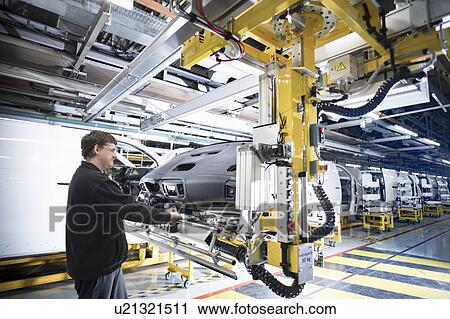 Worker inserting dashboard into vehicle in car factory View Large Photo Image Stock Image - Worker inserting dashboard into vehicle in car factory. Fotosearch