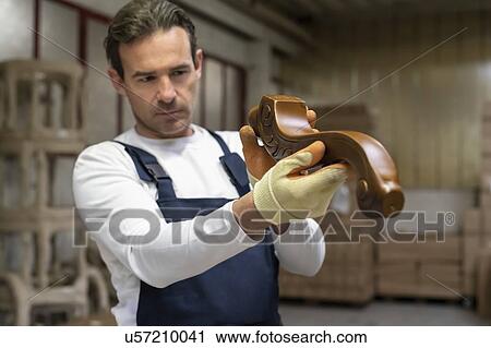 Worker inspecting woodwork in factory View Large Photo Image Stock Image - Worker inspecting woodwork in factory. Fotosearch