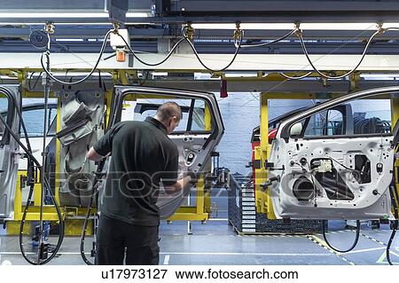Worker on car door assembly line in car factory View Large Photo Image Stock Photo - Worker on car door assembly line in car factory. Fotosearch