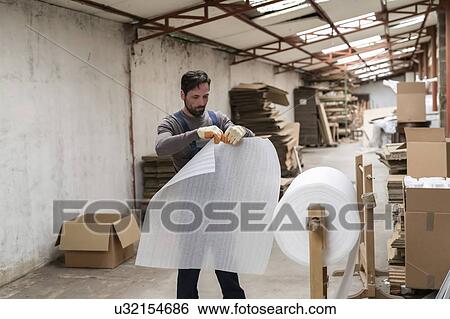 Worker preparing plastic foam in factory View Large Photo Image Stock Photograph - Worker preparing plastic foam in factory. Fotosearch