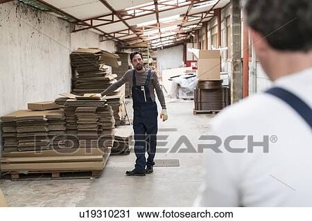 Worker resting hand on stack of cardboard boxes in factory View Large Photo Image Stock Image - Worker resting hand on stack of cardboard boxes in factory. Fotosearch