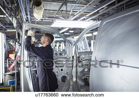Worker sanding van body in car factory View Large Photo Image Stock Image - Worker sanding van body in car factory. Fotosearch