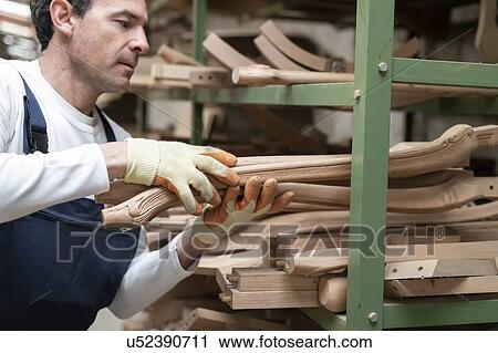 Worker storing wooden furniture legs onto shelf View Large Photo Image Stock Image - Worker storing wooden furniture legs onto shelf. Fotosearch