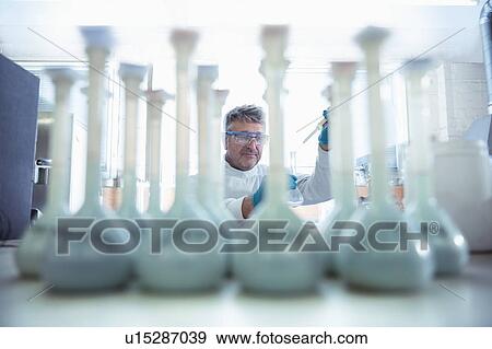 Worker testing samples of titanium in titanium recycling plant View Large Photo Image Stock Photo - Worker testing samples of titanium in titanium recycling plant. Fotosearch