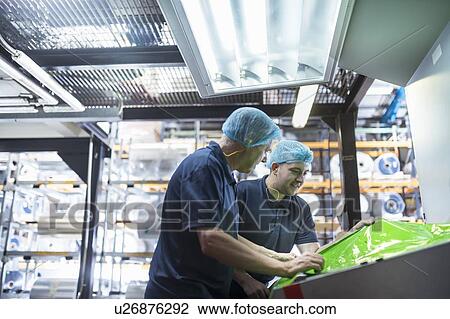 Worker with apprentice in print factory View Large Photo Image Stock Image - Worker with apprentice in print factory. Fotosearch