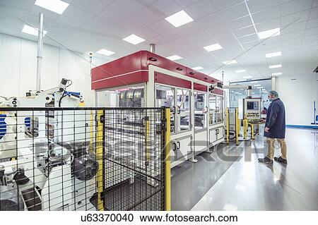 Worker with laser printing machine in print factory View Large Photo Image Stock Image - Worker with laser printing machine in print factory. Fotosearch