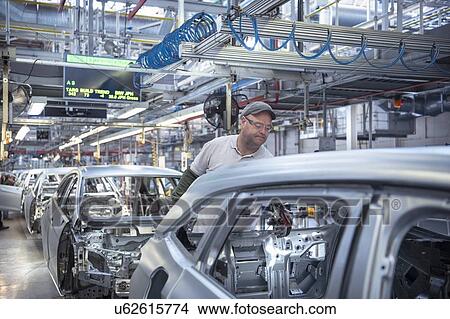 Picture - Workers on car production line in car factory. Fotosearch