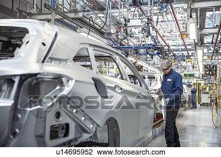 Workers on car production line in car factory View Large Photo Image Stock Image - Workers on car production line in car factory. Fotosearch