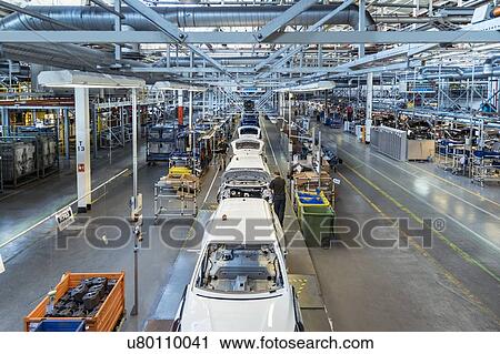 Stock Image - Workers on car production line in car factory. Fotosearch