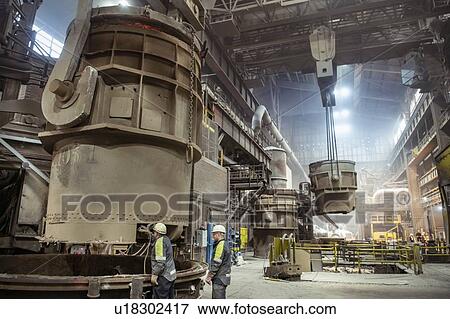Workers preparing molten steel ladle in steelworks View Large Photo Image Stock Photo - Workers preparing molten steel ladle in steelworks. Fotosearch