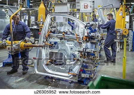 Workers spot welding car door in car factory View Large Photo Image Stock Image - Workers spot welding car door in car factory. Fotosearch