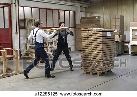Workers stacking cardboard box on pallet in factory View Large Photo Image Stock Photography - Workers stacking cardboard box on pallet in factory. Fotosearch