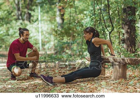 Stock Image - Young couple exercising outdoors. Fotosearch