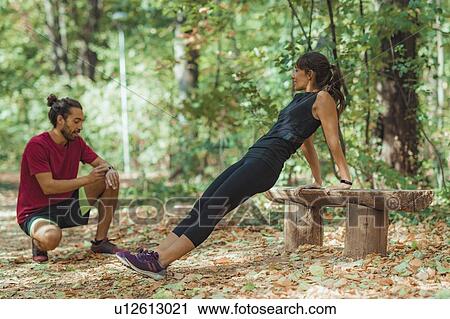 Young couple exercising outdoors View Large Photo Image Stock Image - Young couple exercising outdoors. Fotosearch