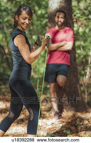 Young couple exercising with elastic resistance band View Large Photo Image Stock Photo - Young couple exercising with elastic resistance band. Fotosearch