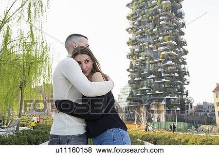 Stock Photo - Young couple hugging in city, Milano, Lombardia, Italy. Fotosearch