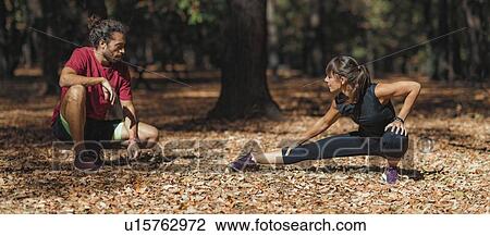 Young couple stretching after training in the park View Large Photo Image Stock Image - Young couple stretching after training in the park. Fotosearch