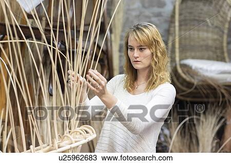Young female basket maker weaving in workshop View Large Photo Image Stock Image - Young female basket maker weaving in workshop. Fotosearch