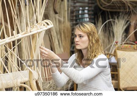 Young female basket maker weaving in workshop View Large Photo Image Stock Photograph - Young female basket maker weaving in workshop. Fotosearch