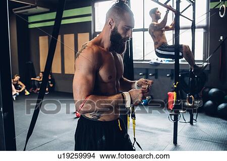 Young men training in gym, on exercise bar View Large Photo Image Picture - Young men training in gym, on exercise bar. Fotosearch