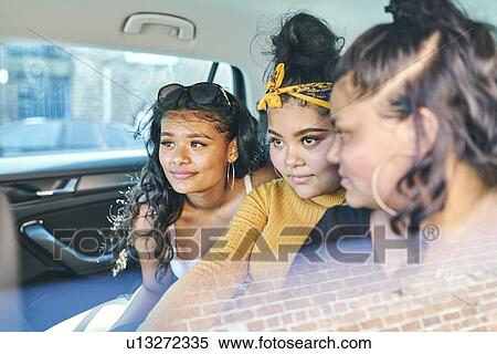 Young woman and teenage sisters in back seat of car View Large Photo Image Stock Photography - Young woman and teenage sisters in back seat of car. Fotosearch
