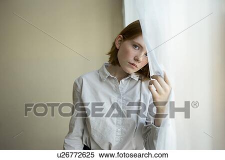 Young woman holding white curtain View Large Photo Image Stock Photography - Young woman holding white curtain. Fotosearch