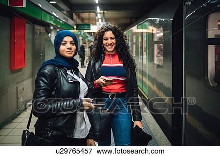 Young woman in hijab with friend in subway station, portrait View Large Photo Image Stock Photo - Young woman in hijab with friend in subway station, portrait. Fotosearch