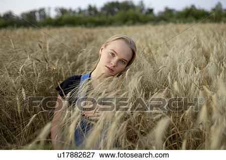 Young woman in wheat field View Large Photo Image Stock Photo - Young woman in wheat field. Fotosearch