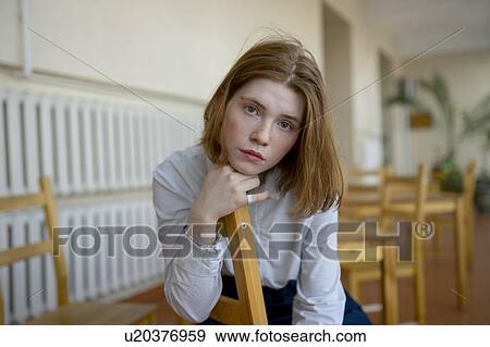 Young woman leaning on wooden chair View Large Photo Image Stock Photo - Young woman leaning on wooden chair. Fotosearch