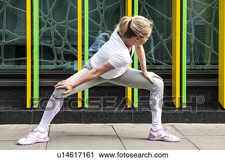 Young woman practicing yoga pose on city sidewalk, full length View Large Photo Image Stock Image - Young woman practicing yoga pose on city sidewalk, full length. Fotosearch