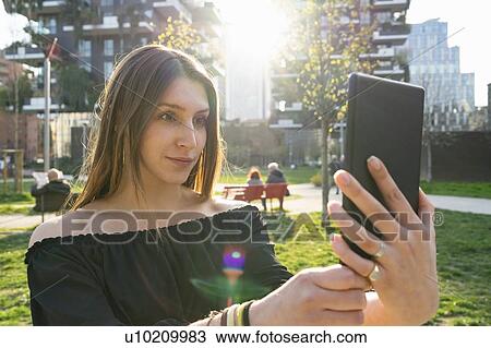 Young woman taking selfie with digital tablet in city, Milano, Lombardia, Italy View Large Photo Image Stock Image - Young woman taking selfie with digital tablet in city, Milano, Lombardia, Italy. Fotosearch