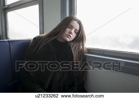 Young woman wearing black fur coat on train View Large Photo Image Stock Image - Young woman wearing black fur coat on train. Fotosearch